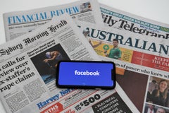 An illustration image shows a phone screen with the "Facebook" logo and Australian newspapers in Canberra