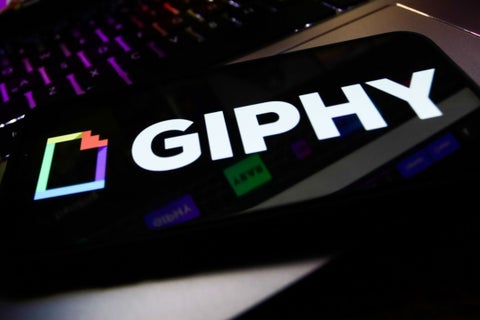 Giphy logo displayed on a phone screen Photographer: Getty Images/NurPhoto