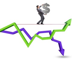 Businessman balancing on tightrope on line chart