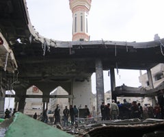 Palestinos en los restos de la mezquita de Al-Huda