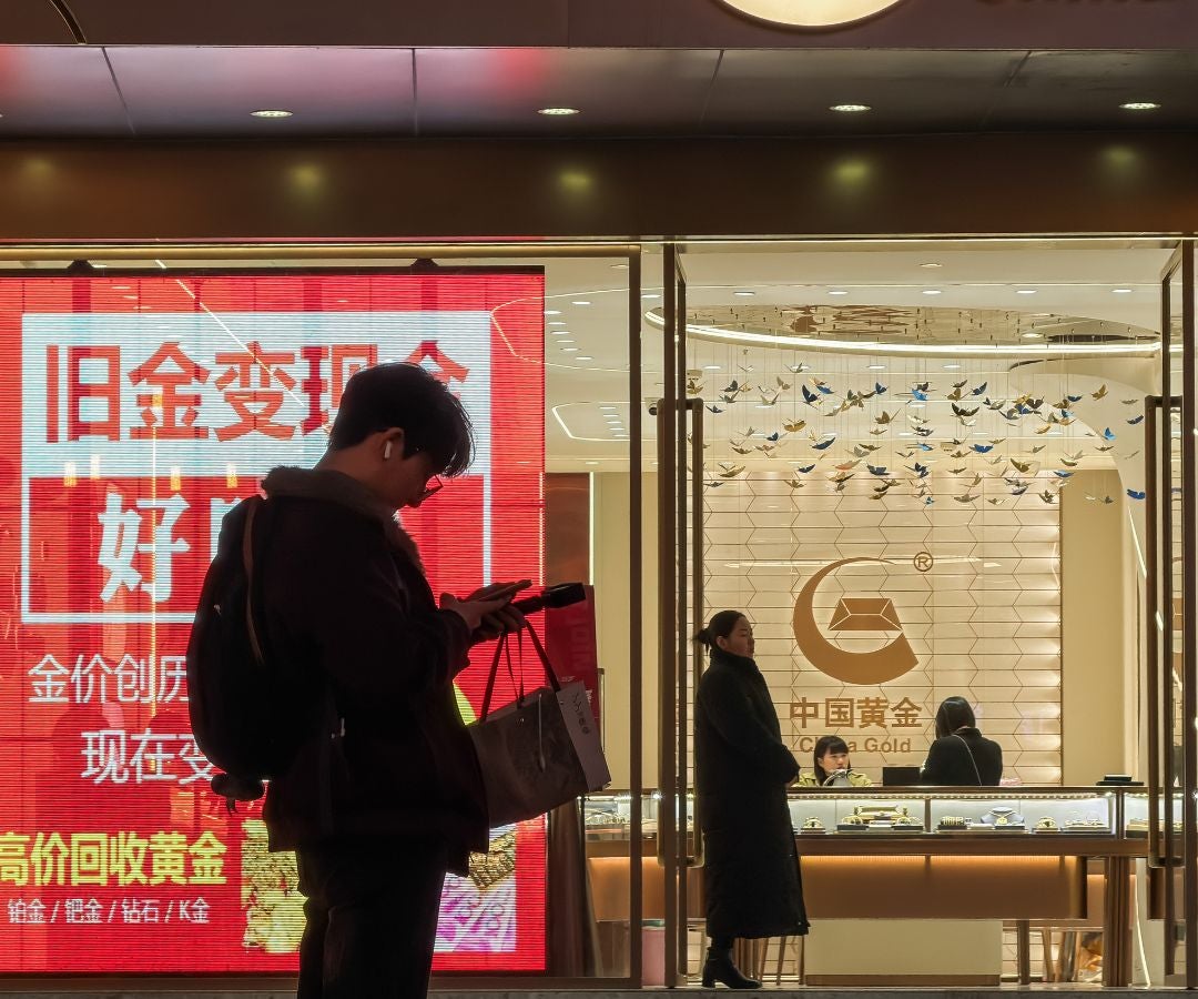 Un peatón mira un teléfono inteligente, en Chongqing, China.