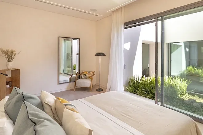 Uno de los ocho dormitorios en suite. Todos tienen jardín interior al otro lado del cristal.